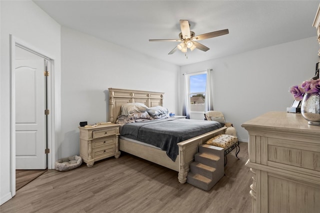 bedroom featuring ceiling fan and hardwood / wood-style flooring