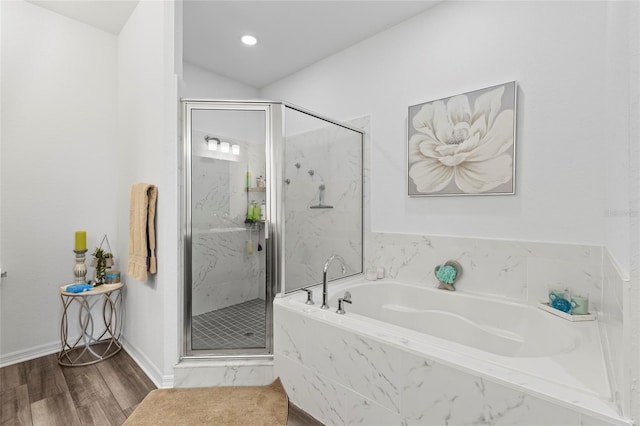 bathroom with hardwood / wood-style floors and separate shower and tub