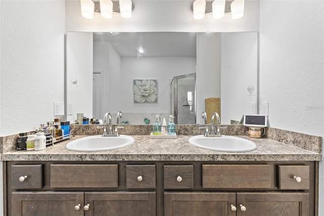 bathroom with a shower with door and vanity