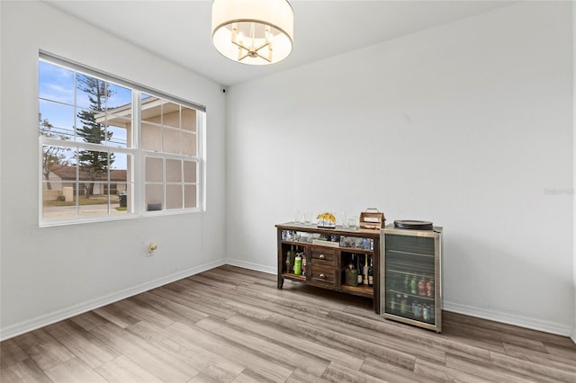 spare room featuring hardwood / wood-style flooring and an inviting chandelier