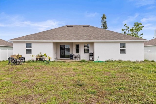 rear view of house featuring a patio area and a yard