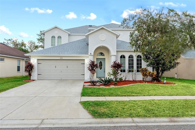 view of front facade with a front lawn and a garage