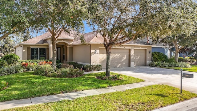 view of front of home featuring a garage and a front lawn