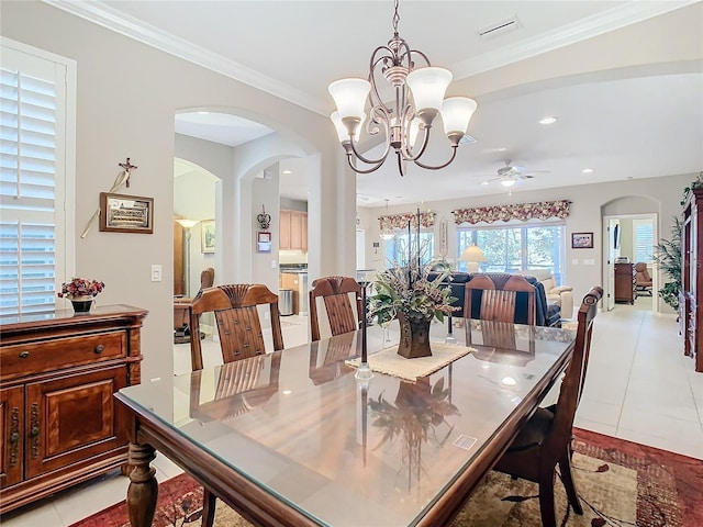 dining area featuring light tile patterned floors, ceiling fan with notable chandelier, and ornamental molding