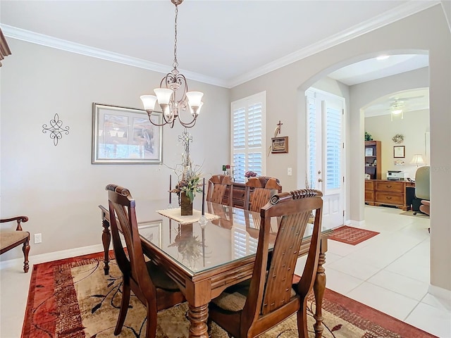 tiled dining area featuring ornamental molding and a chandelier