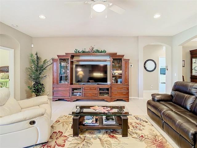 tiled living room with ceiling fan