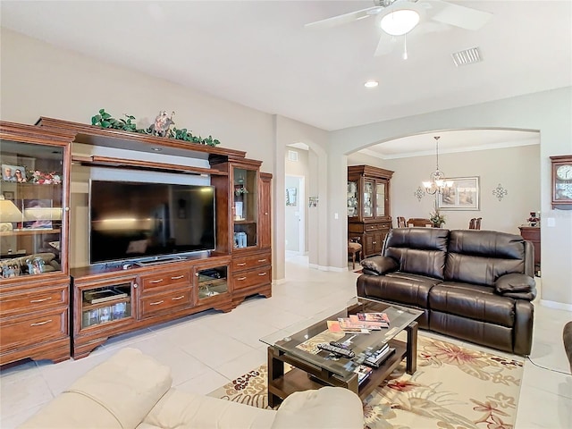 living room with ceiling fan with notable chandelier, light tile patterned flooring, and ornamental molding