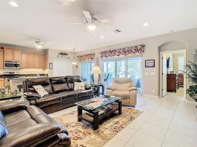 living room with light tile patterned floors and ceiling fan