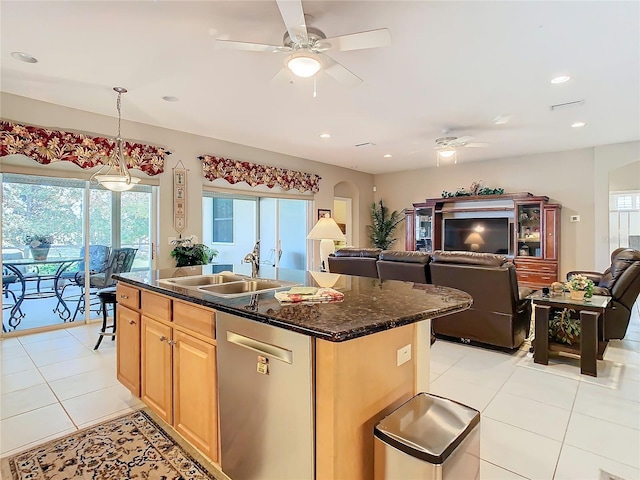 kitchen featuring dishwasher, light brown cabinets, sink, an island with sink, and light tile patterned flooring