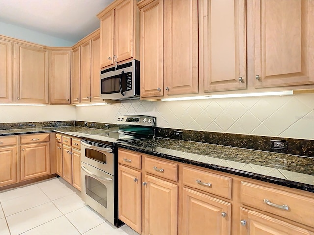 kitchen with light tile patterned flooring and stainless steel appliances