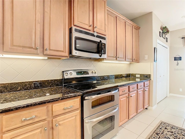 kitchen featuring light tile patterned floors and appliances with stainless steel finishes