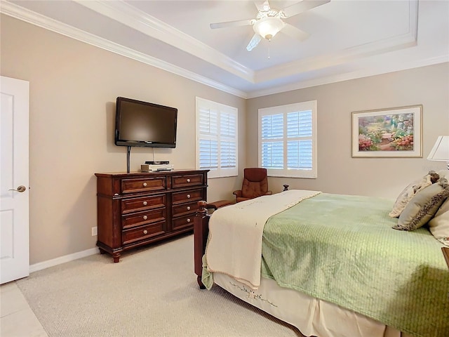 bedroom with light colored carpet, ceiling fan, a raised ceiling, and ornamental molding