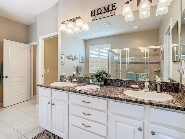 bathroom featuring tile patterned flooring, vanity, and an enclosed shower