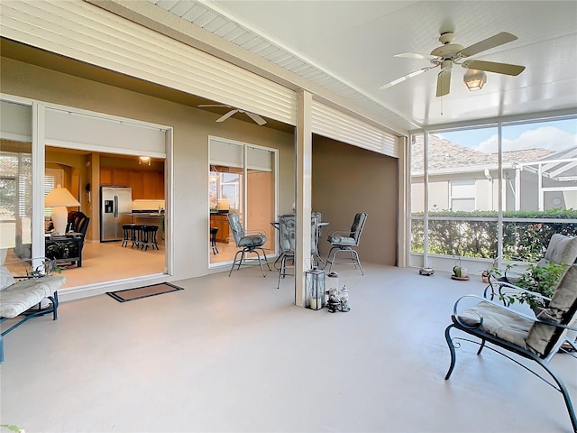 sunroom featuring ceiling fan