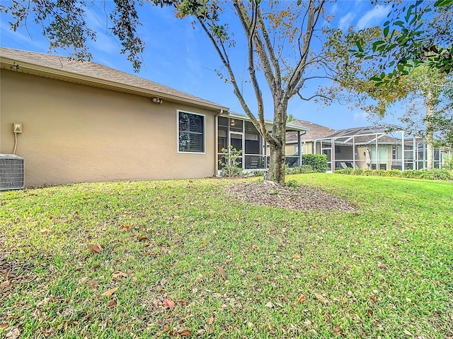 view of yard featuring a sunroom, cooling unit, and a lanai