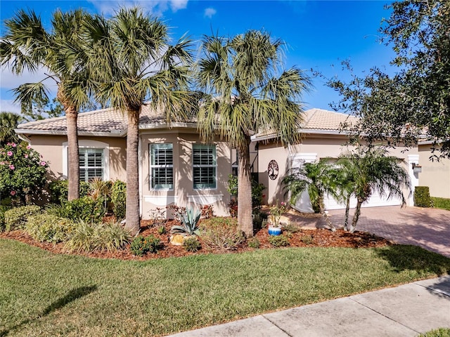 mediterranean / spanish-style house with a front lawn