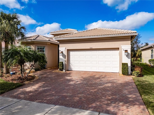 mediterranean / spanish house featuring a garage