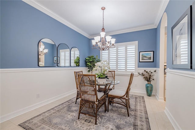 dining area featuring ornamental molding, light tile patterned floors, and a notable chandelier