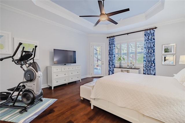 bedroom with dark hardwood / wood-style flooring, access to outside, a raised ceiling, ceiling fan, and crown molding