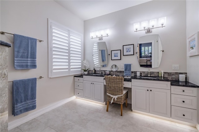 bathroom featuring tile patterned flooring and vanity