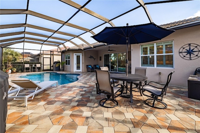 view of swimming pool featuring a patio area, ceiling fan, and a lanai