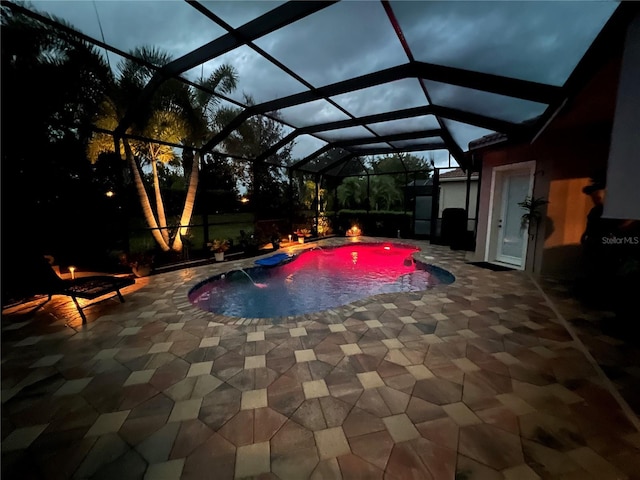 view of pool featuring pool water feature, a patio area, and a lanai