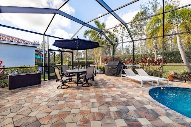 view of patio / terrace with grilling area and a lanai