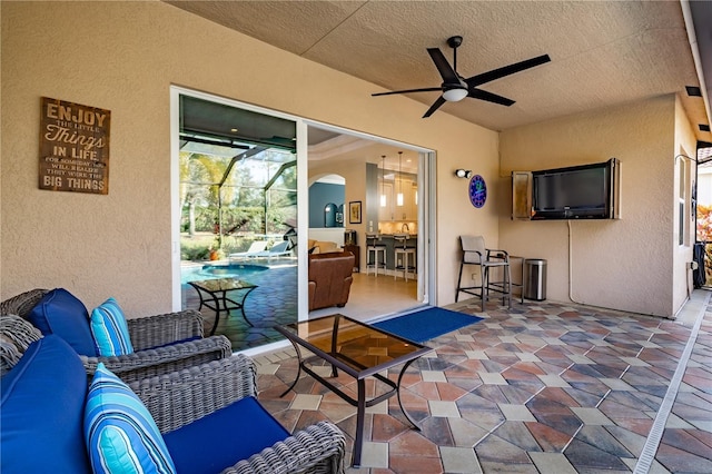 view of patio featuring exterior bar, outdoor lounge area, ceiling fan, and a lanai