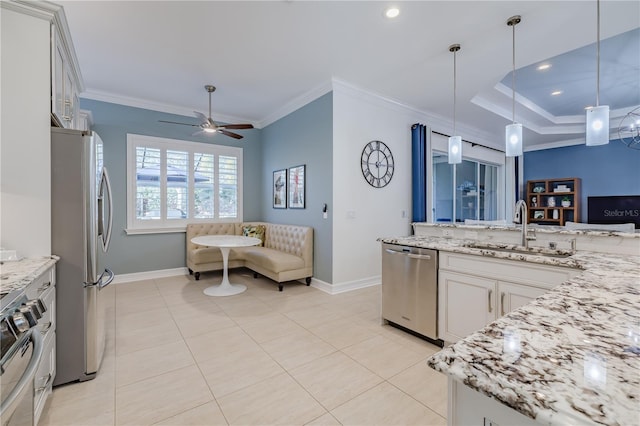 kitchen with pendant lighting, white cabinetry, sink, and appliances with stainless steel finishes