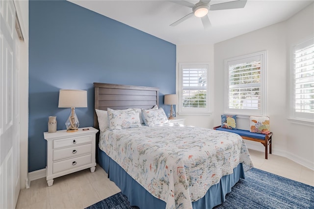 tiled bedroom with ceiling fan