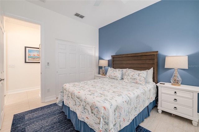 bedroom featuring light tile patterned floors, a closet, and ceiling fan