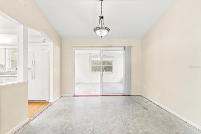 spare room with concrete floors and ceiling fan