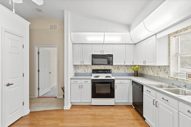 kitchen with ceiling fan, sink, black appliances, white cabinets, and light hardwood / wood-style floors