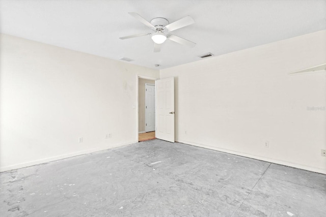 spare room featuring concrete floors and ceiling fan