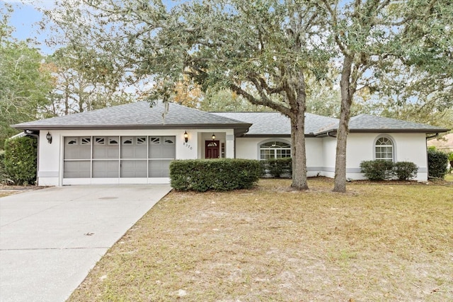 ranch-style home with a garage and a front yard