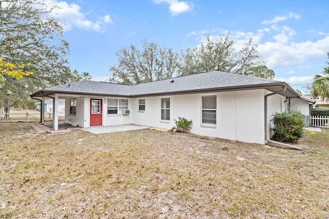 rear view of property with a lawn and a patio area