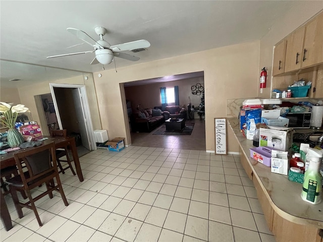 kitchen with ceiling fan, light brown cabinets, and light tile patterned floors