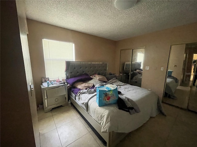 tiled bedroom with a textured ceiling