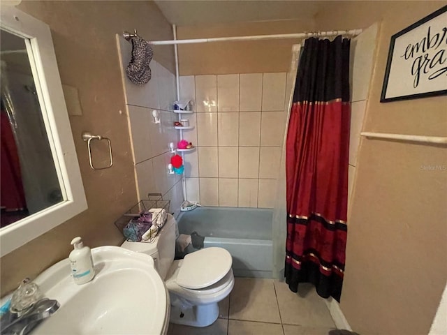 full bathroom with tile patterned flooring, toilet, shower / bath combo with shower curtain, and sink