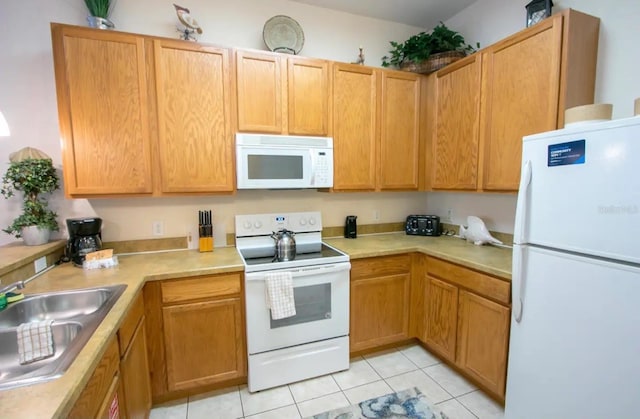 606 Gran Bahama Blvd Unit 29-606, Davenport, FL 33897 - kitchen with white appliances, light tile patterned floors, and light countertops