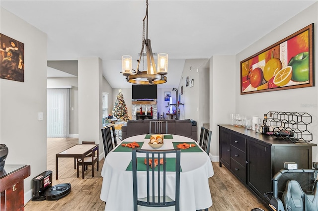 dining room with a chandelier and light hardwood / wood-style floors