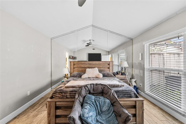 bedroom with ceiling fan, light hardwood / wood-style floors, and lofted ceiling