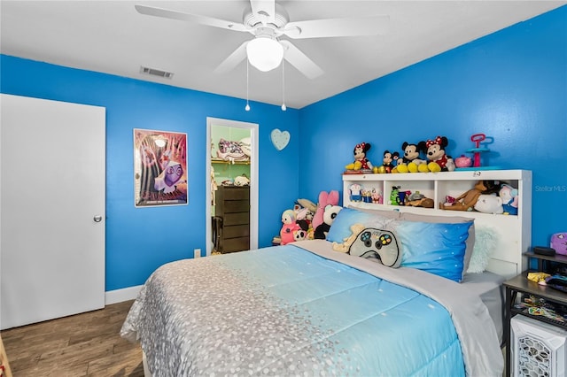 bedroom with ceiling fan and hardwood / wood-style floors