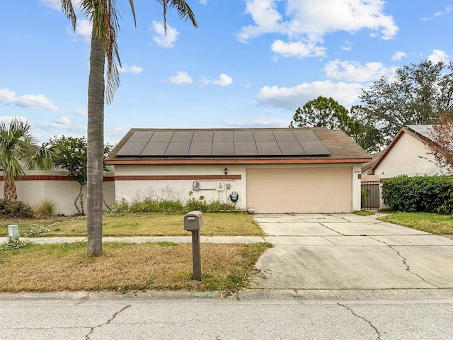 view of front of house with solar panels and a garage