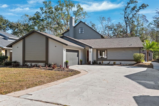 view of front of house featuring a garage and a front lawn