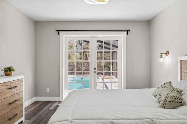 bedroom with dark hardwood / wood-style flooring and a textured ceiling