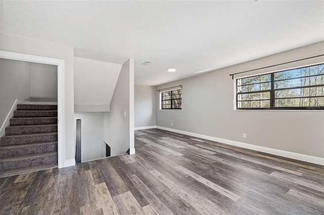 unfurnished living room with hardwood / wood-style flooring and a wealth of natural light