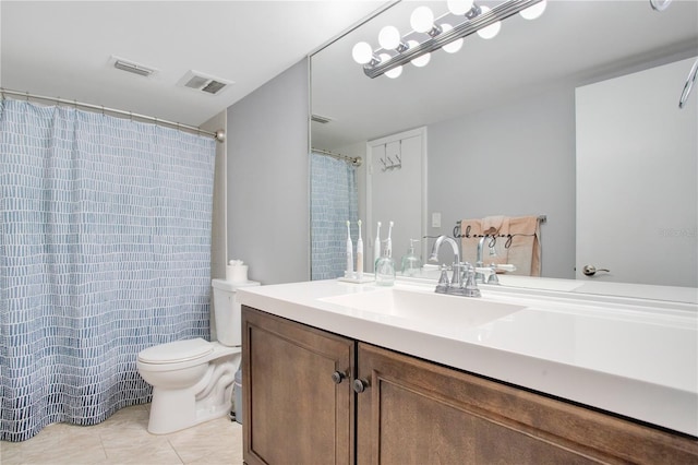 bathroom with tile patterned floors, vanity, and toilet