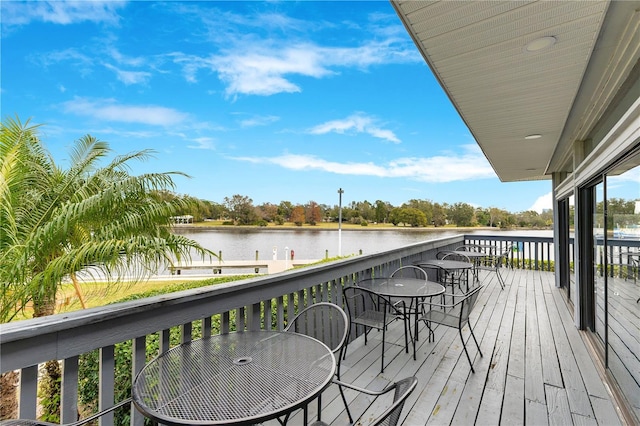 wooden terrace featuring a water view