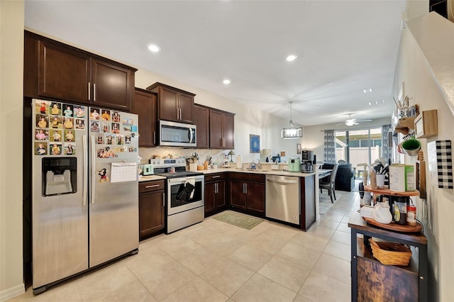 kitchen featuring dark brown cabinetry, stainless steel appliances, ceiling fan, light tile patterned floors, and decorative light fixtures